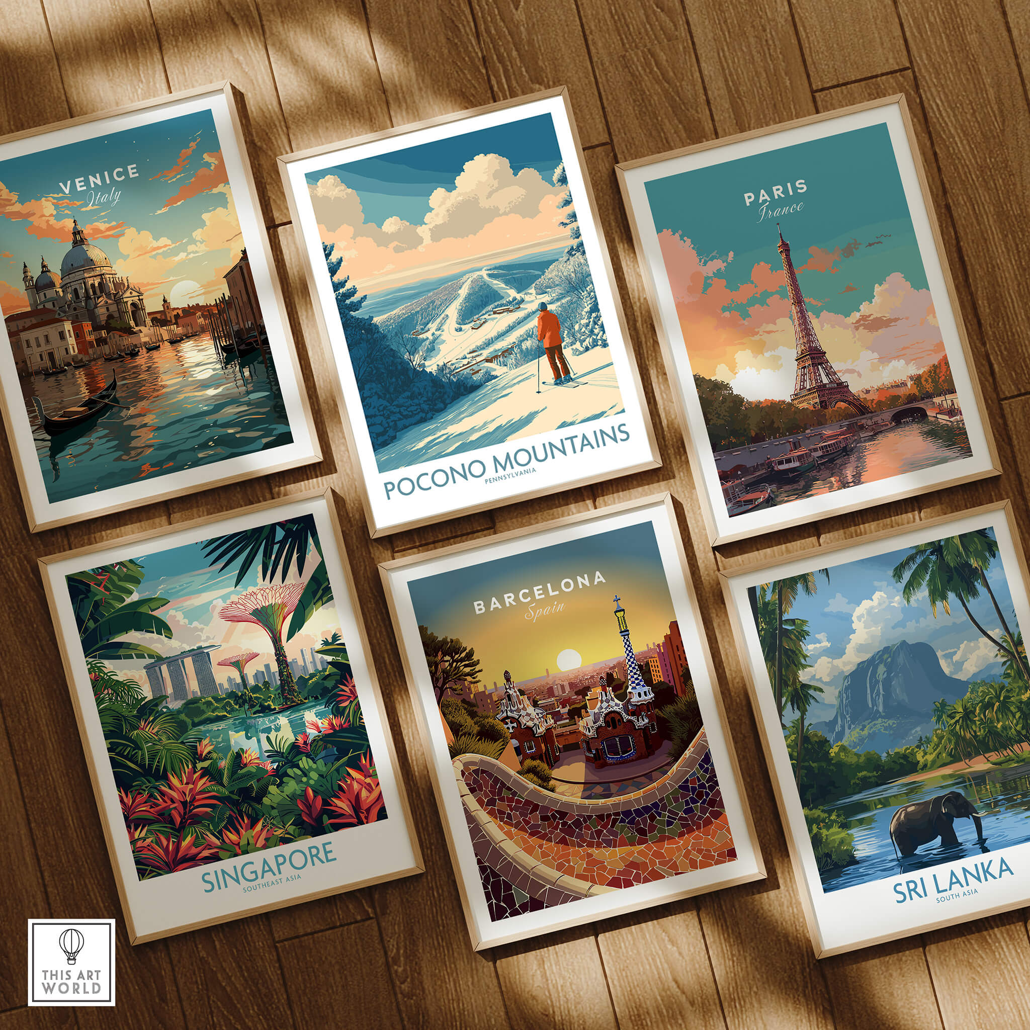 Framed travel posters featuring Venice, Pocono Mountains, Paris, Singapore, Barcelona, and Sri Lanka on wooden floor.