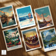 Set of framed travel posters featuring Venice, Pocono Mountains, Paris, Singapore, Barcelona, and Sri Lanka on a wooden floor.