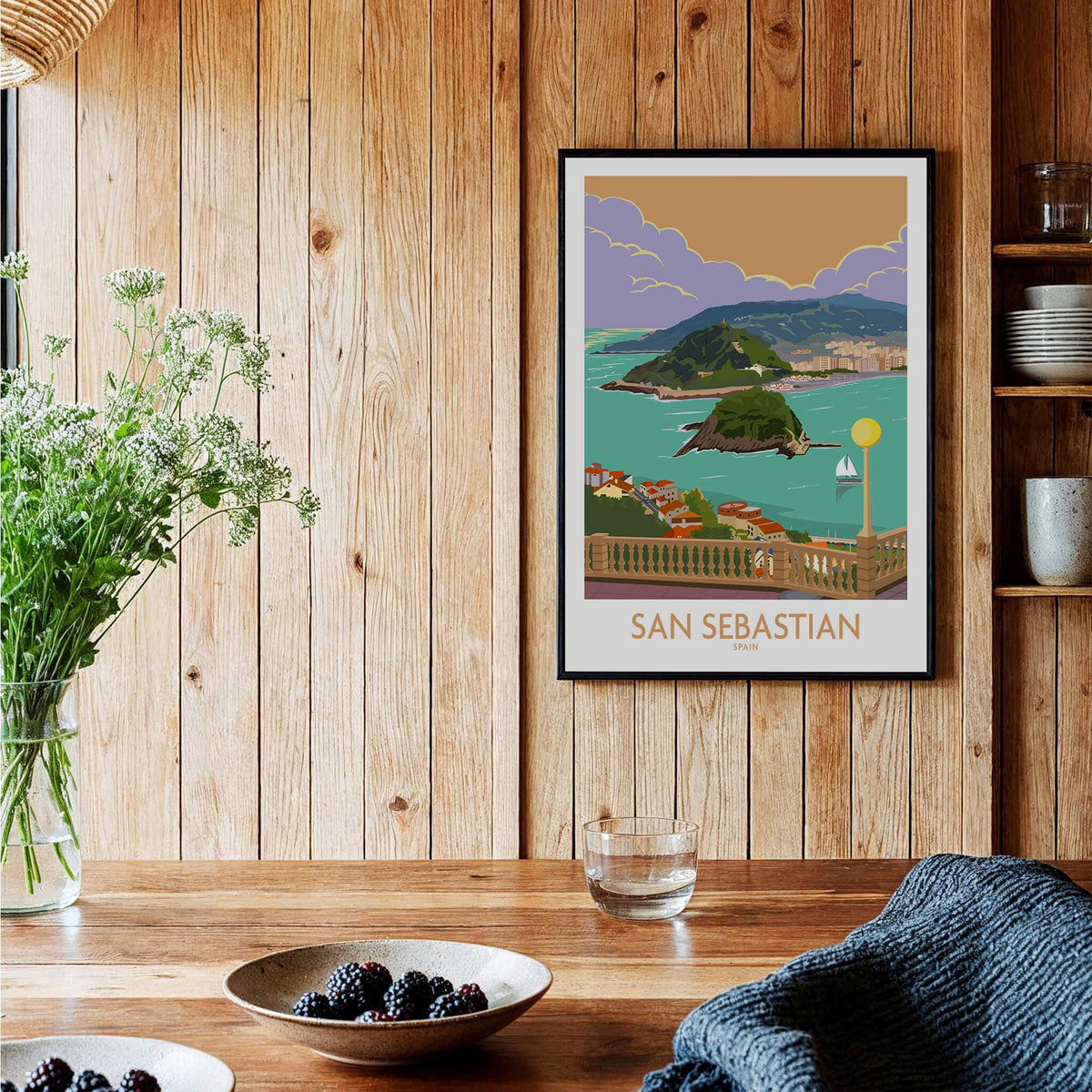 San Sebastian Poster Print featuring the seaside city of Donostia-San Sebastian in vibrant colors on a wooden wall.