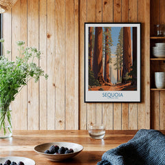 Framed Sequoia National Park art print hanging in a rustic wood kitchen with berries on table