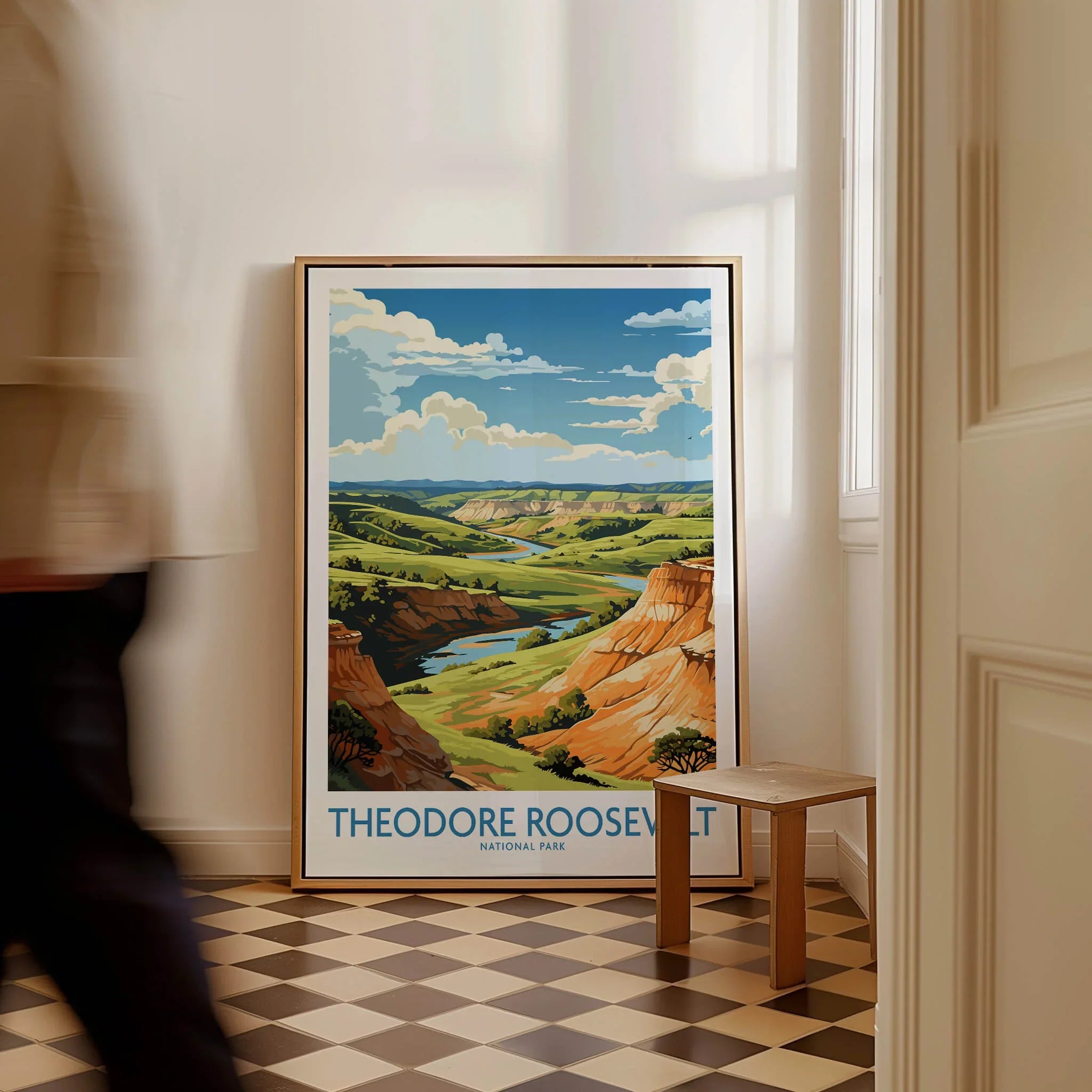 Framed Theodore Roosevelt National Park travel poster on floor in bright hallway