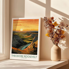 Theodore Roosevelt National Park print on windowsill with dried flowers in vase, sunlight and shadows.