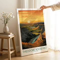 Hand holding Theodore Roosevelt National Park print in sunlit room with scenic landscape art