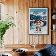 Val-d'Isère Ski Poster displayed in a cozy setting with wooden wall and ski equipment, ideal for winter sports enthusiasts.