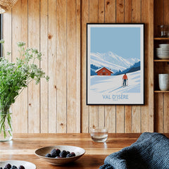 Val-d'Isère Print France ski poster hanging on a wooden wall with a mountain backdrop.