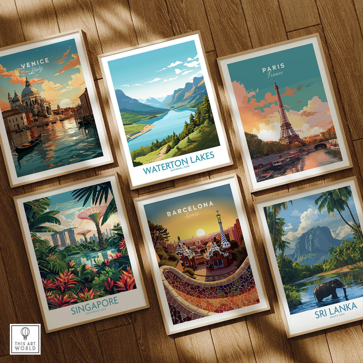 Set of six framed travel posters featuring Venice, Waterton Lakes, Paris, Singapore, Barcelona, and Sri Lanka on a wooden floor.