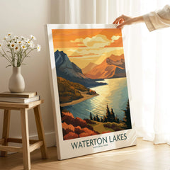 Hand holding Waterton Lakes National Park travel art print in sunlit home decor setting