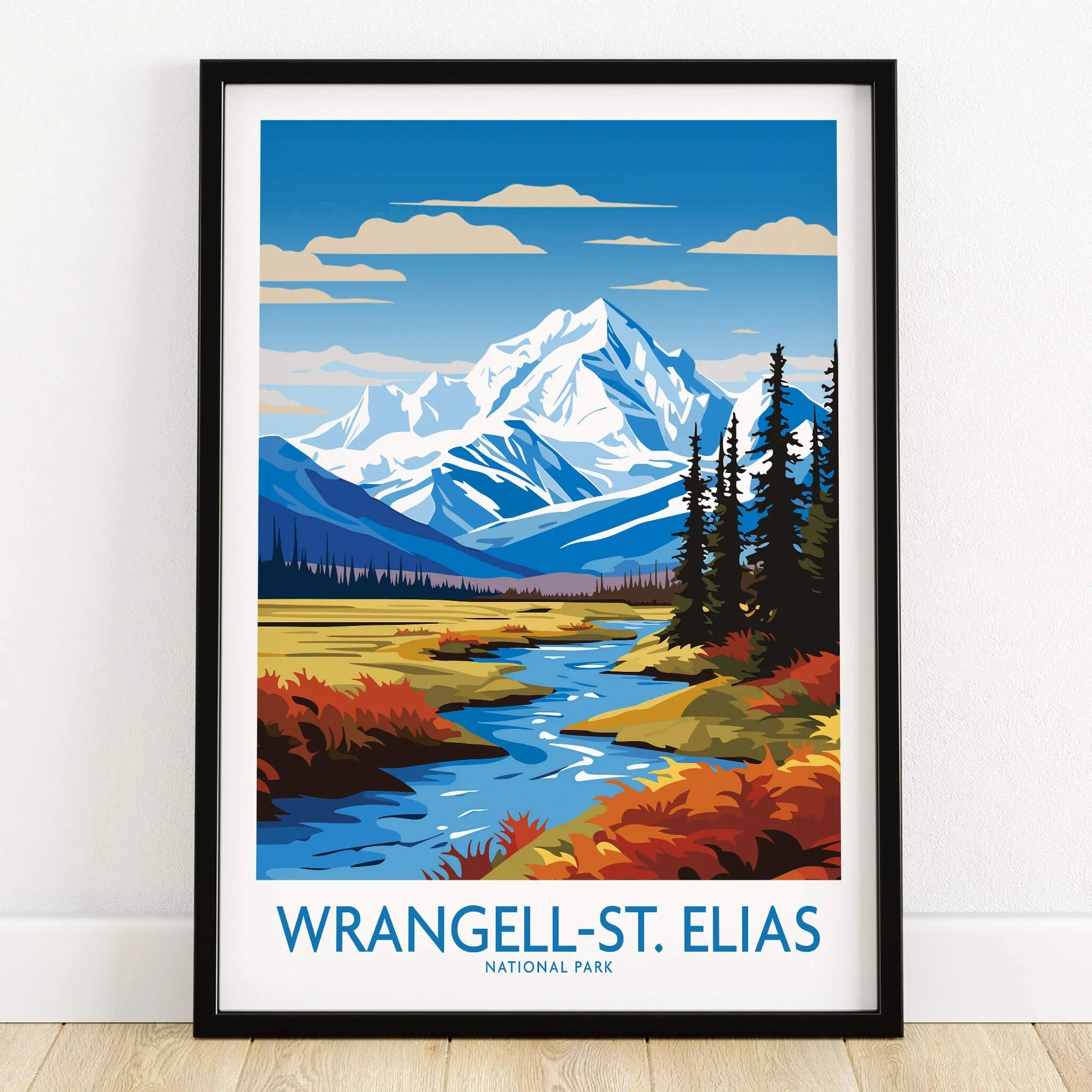 Wrangell-St. Elias National Park art print with snowy mountains and river, in black frame on wooden floor.