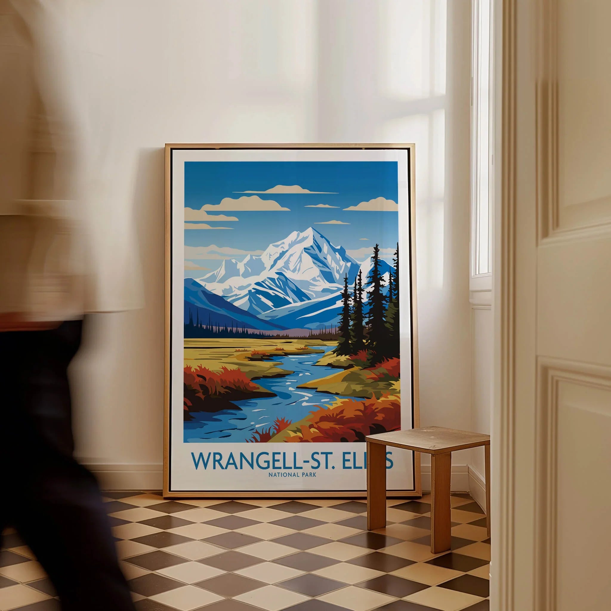 Framed Wrangell-St. Elias National Park travel poster on floor with man walking past