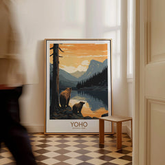 Framed Yoho National Park art print with bears and mountains, leaning on a floor indoors.