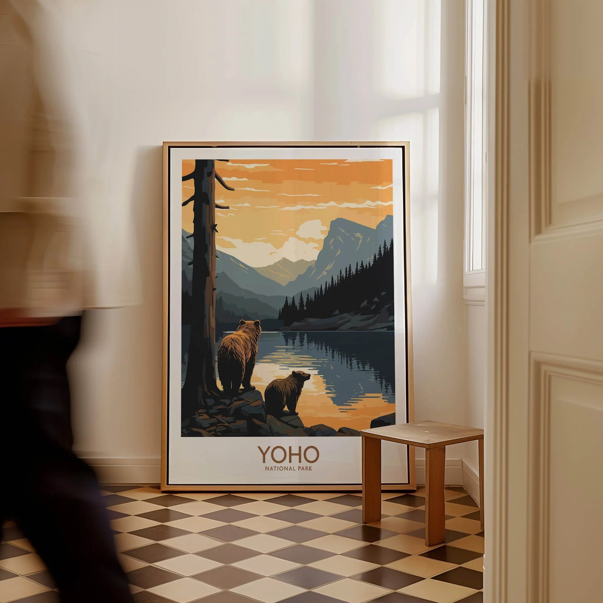 Framed Yoho National Park art print with bears and mountains, leaning on a floor indoors.