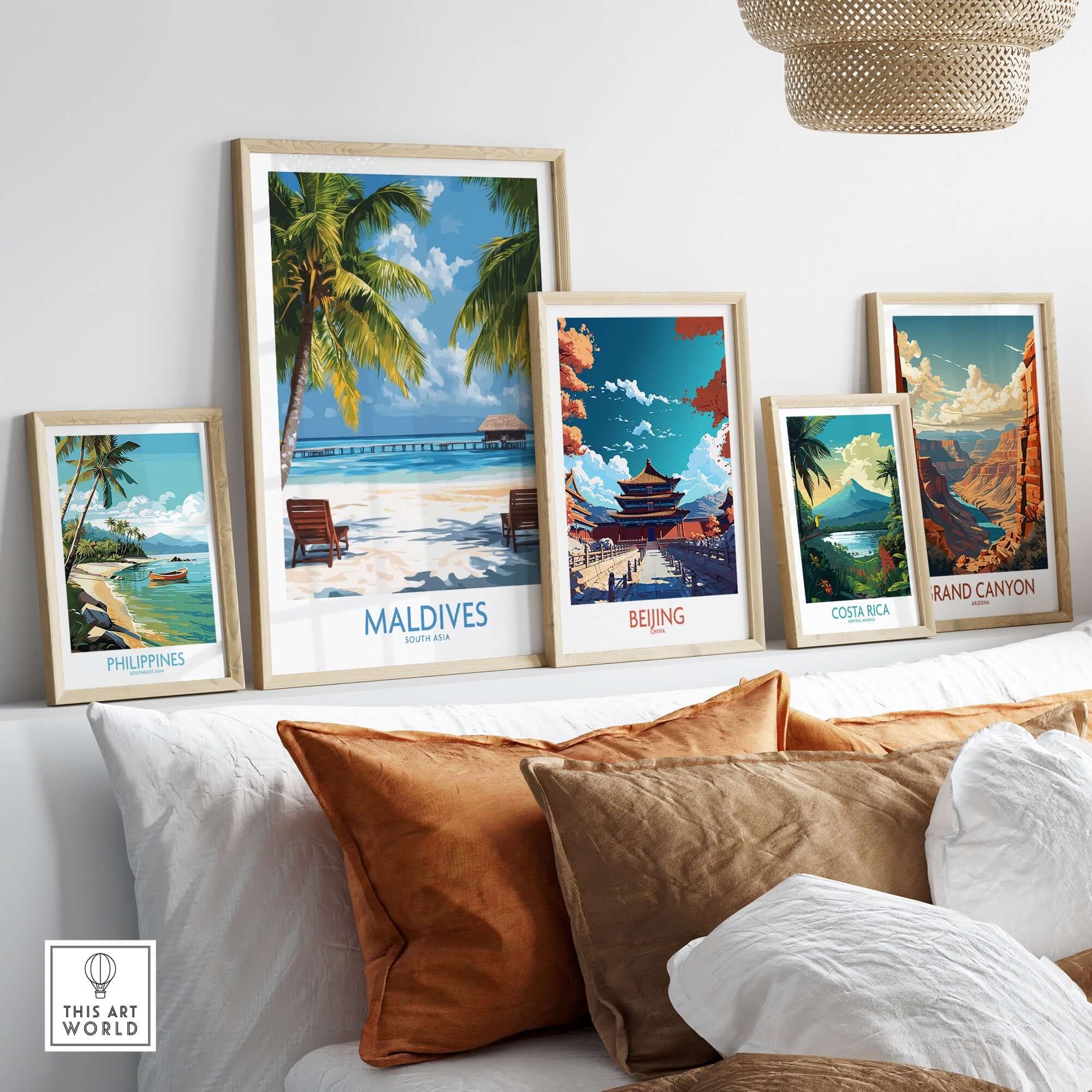 Maldives Wall Art Poster of Tropical Beach displayed among framed artworks on a stylish sofa.
