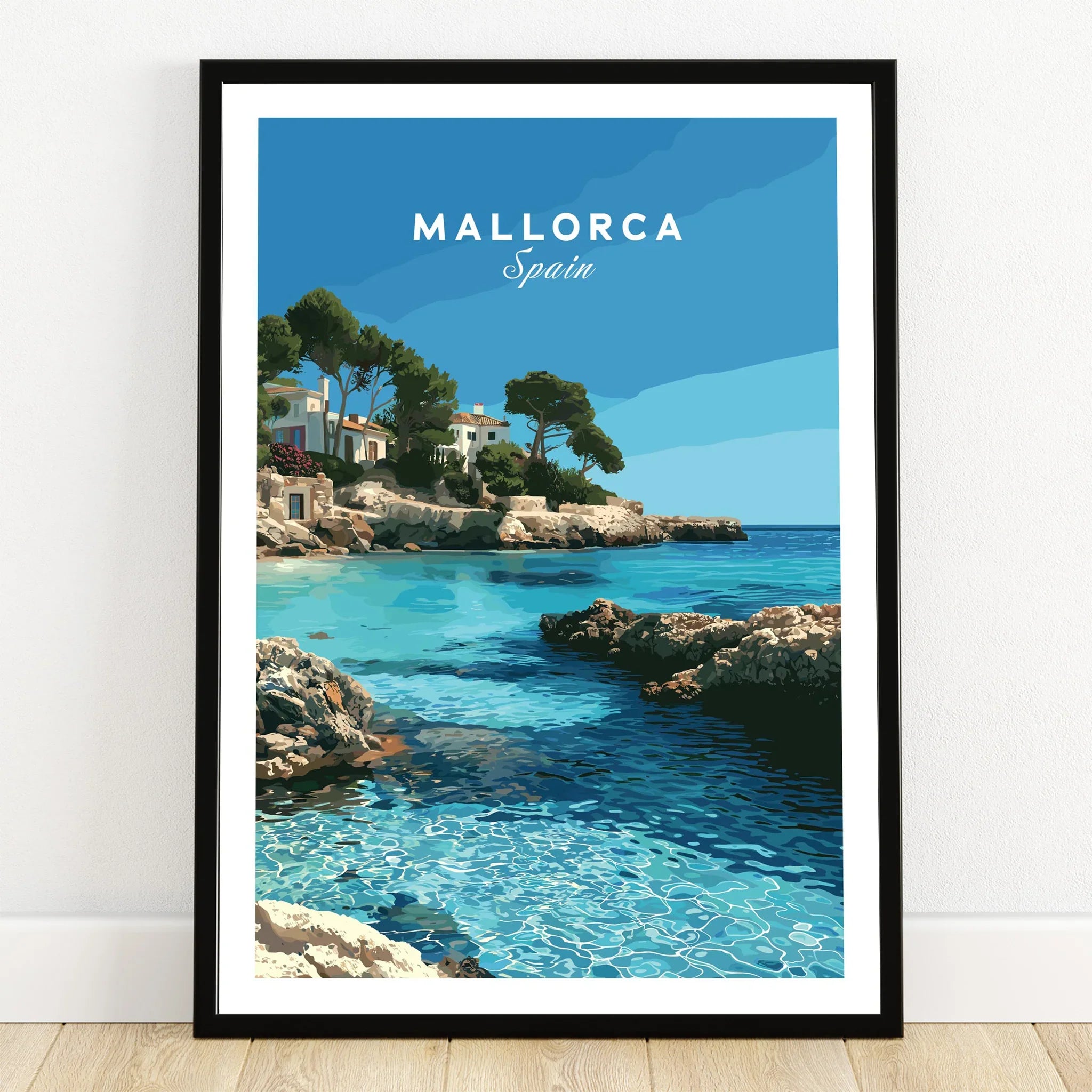 Mallorca Spain Coastal Cove Travel Poster — art print in black frame on wooden floor