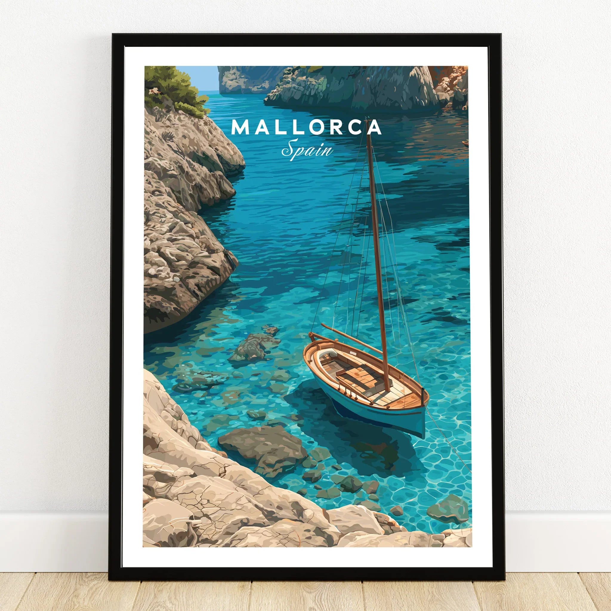 Mallorca Spain Sailboat Cove Travel Poster — art print in black frame on wooden floor
