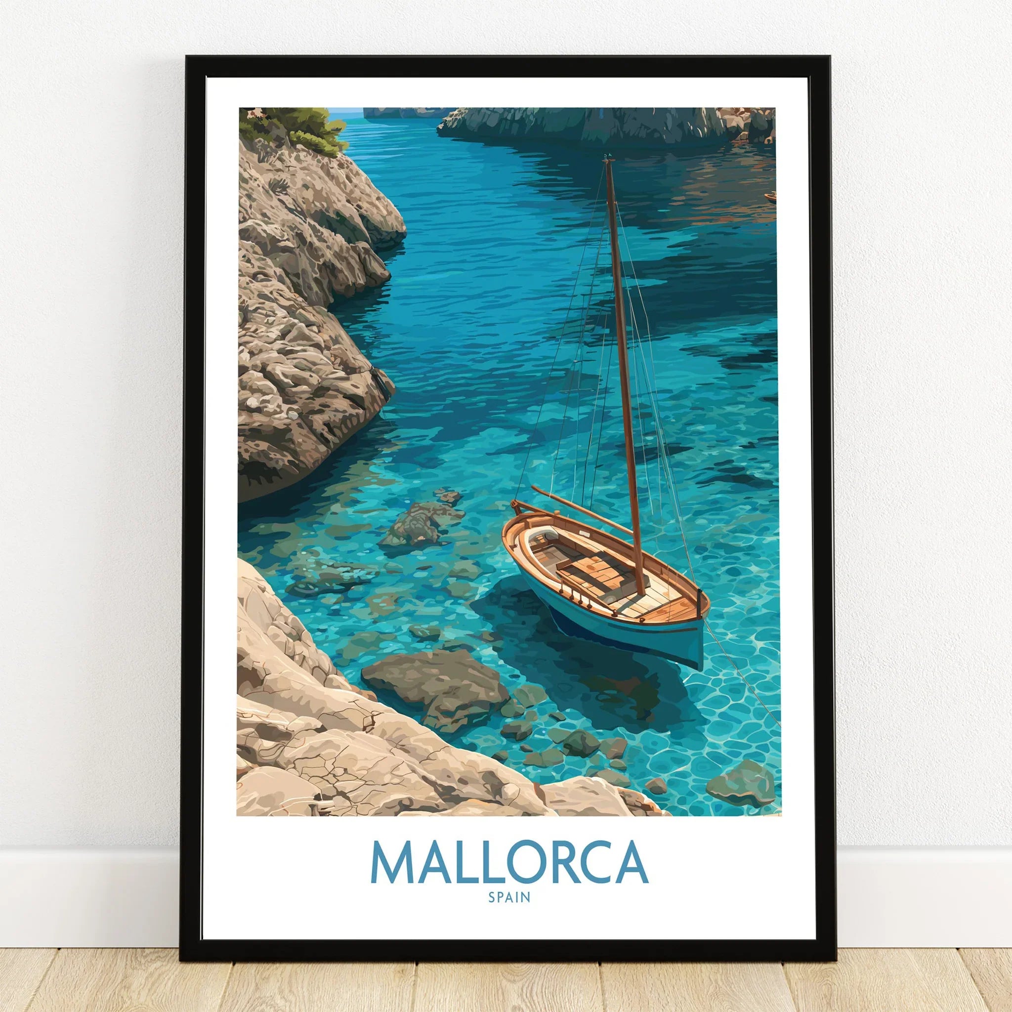 Mallorca Spain Cove Sailboat Wall Art — art print in black frame on wooden floor