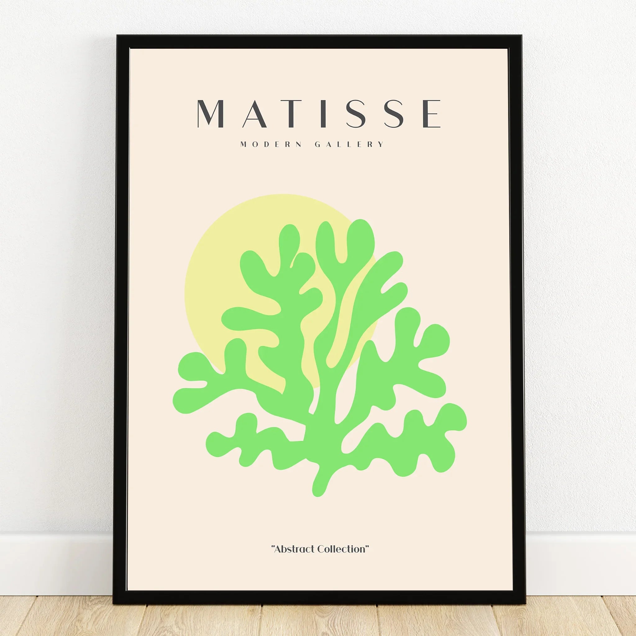 Modern abstract art print with green botanical shape, yellow circle, black frame