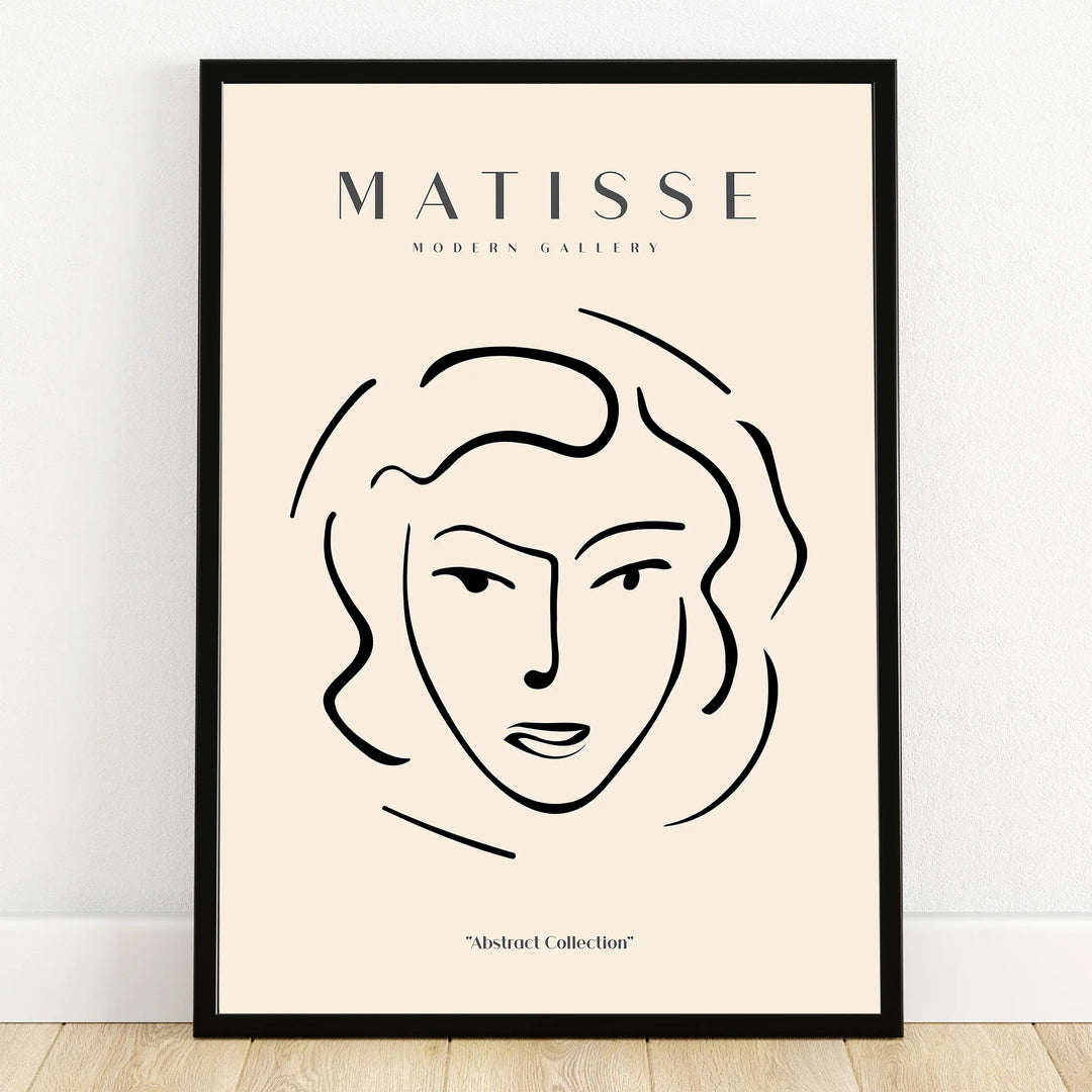 Minimalist Matisse-inspired line art portrait wall art in black frame on floor.
