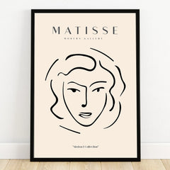 Minimalist Matisse-inspired line art portrait wall art in black frame on floor.