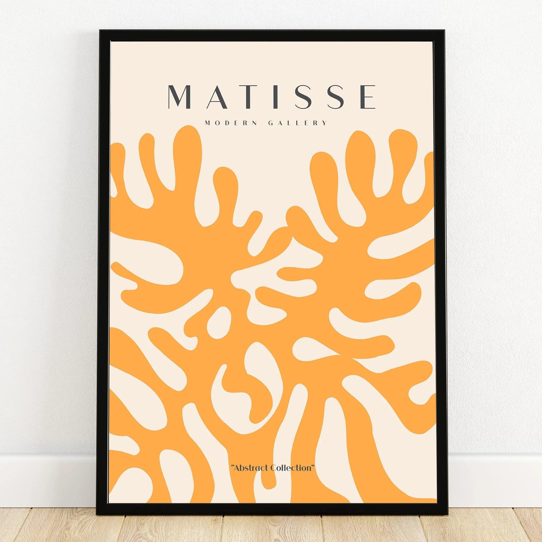 Framed abstract wall art print with orange leaf shapes on cream background, modern decor