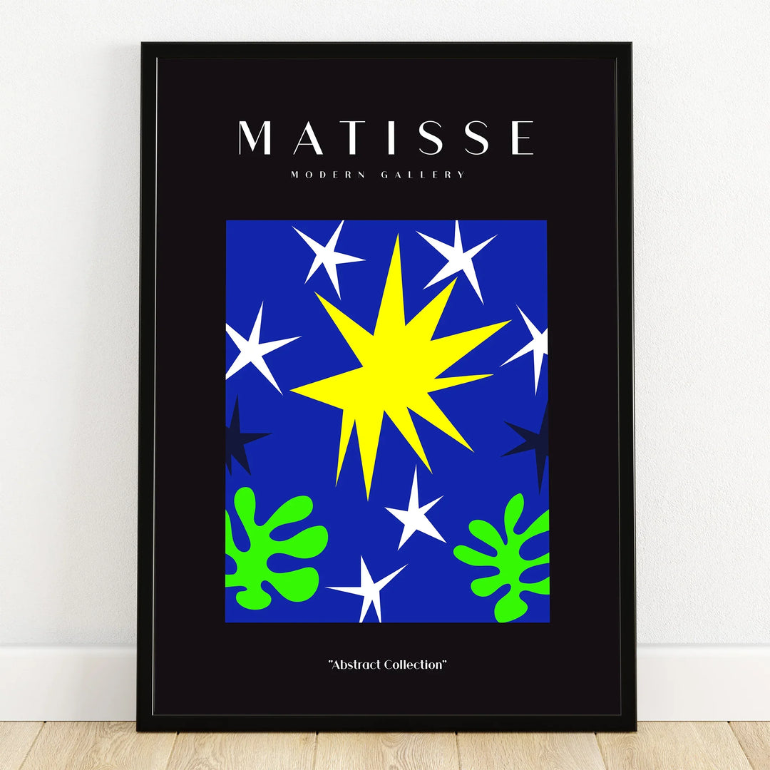 Modern abstract wall art print with blue background, yellow star, white stars, green leaves in black frame