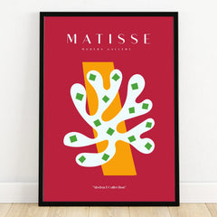 Modern abstract art print with bold shapes in red, white, yellow, and green, black frame