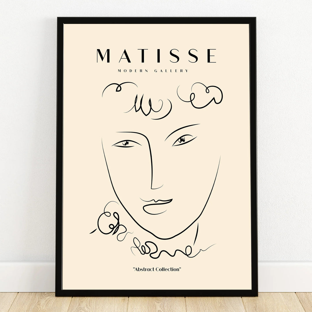 Minimalist abstract face line art print in black frame, Matisse-inspired wall decor.