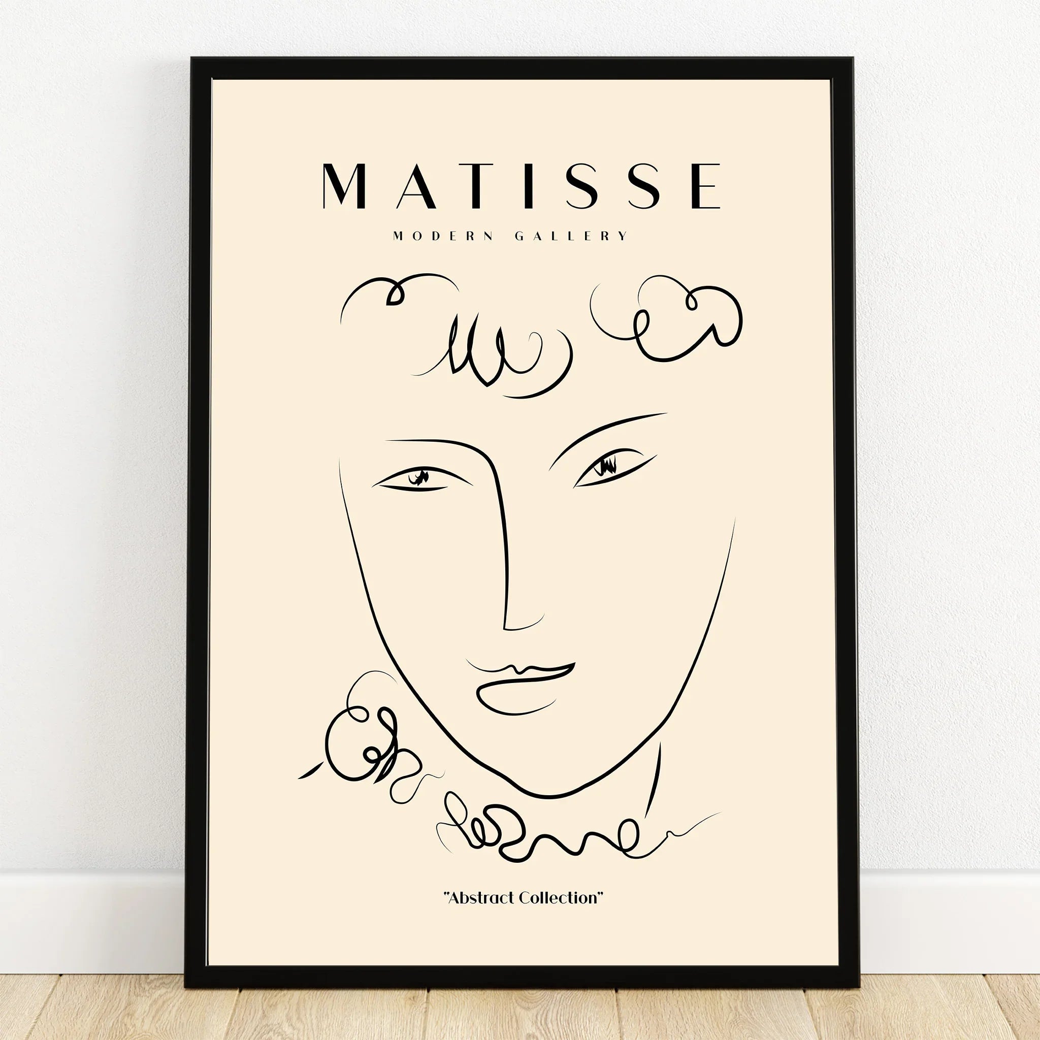Minimalist abstract face line art print in black frame, Matisse-inspired wall decor.