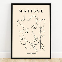 Minimalist abstract face line art print in black frame, modern wall decor