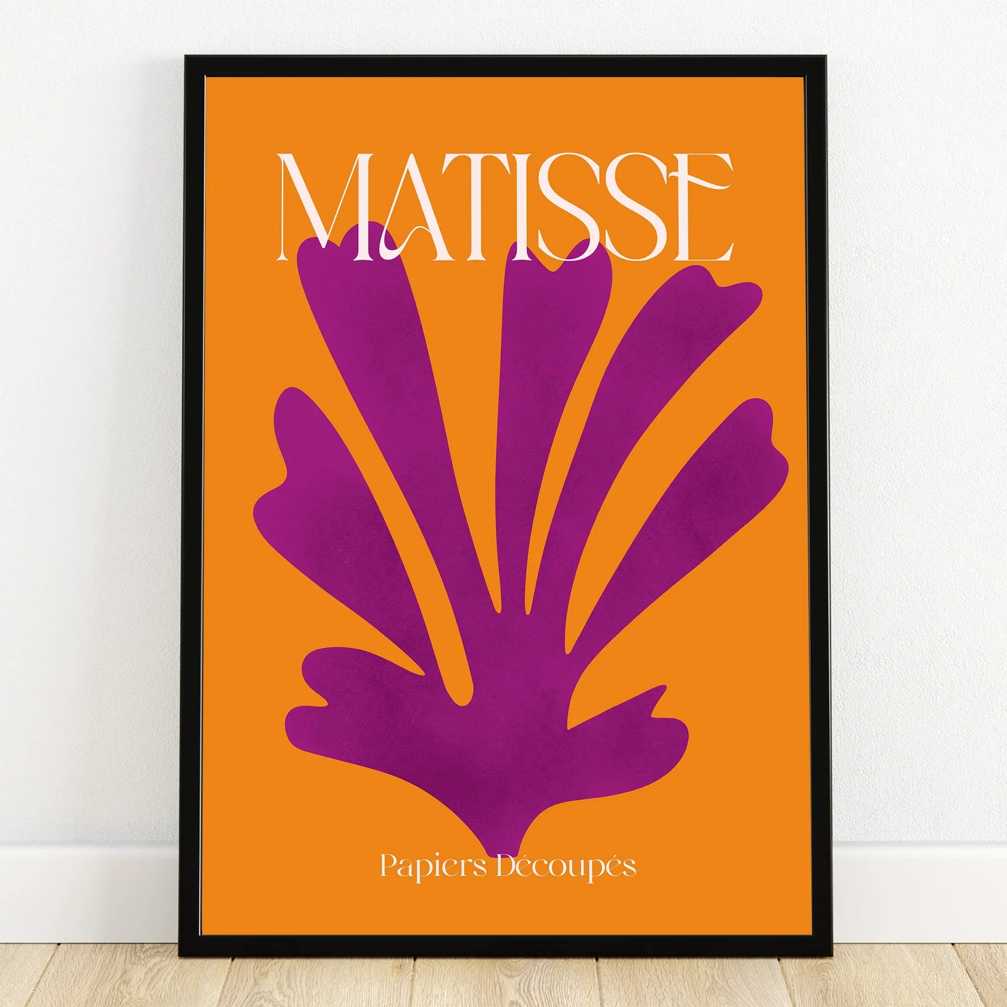 Matisse inspired wall art with bold purple cutout on orange background in black frame