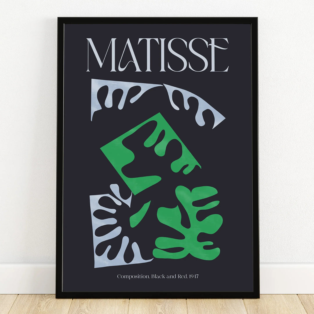 Modern Matisse art print with abstract green and white leaf shapes in a black frame on wall