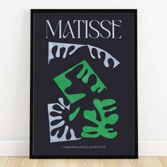 Modern Matisse art print with abstract green and white leaf shapes in a black frame on wall