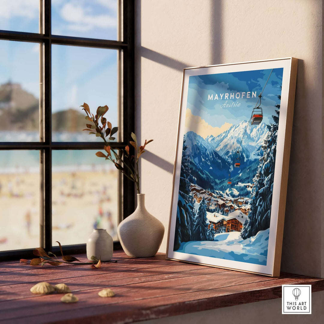 Mayrhofen Ski Print framed on a wooden table, showcasing a beautiful winter mountain scene and ski lift.