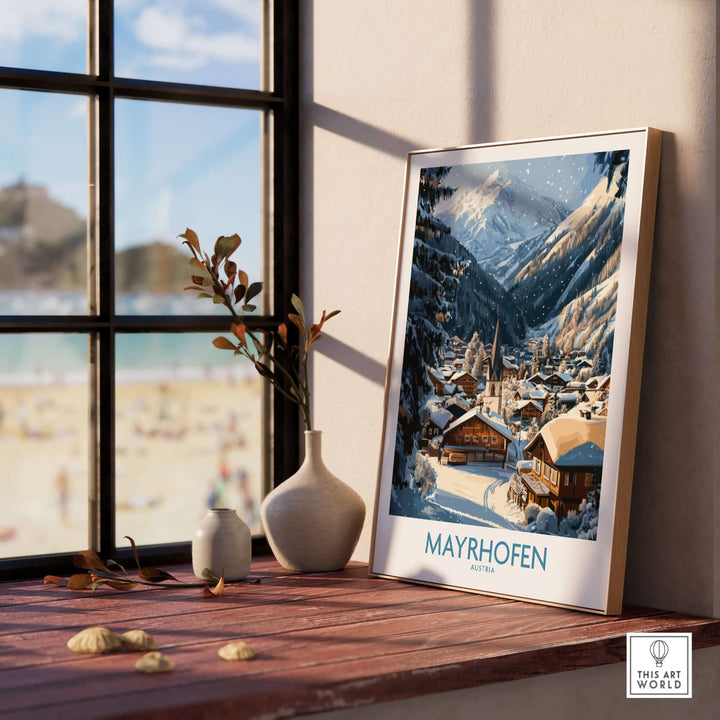 Mayrhofen ski wall art poster displayed on a table by a window, showcasing a snowy mountain village scene.