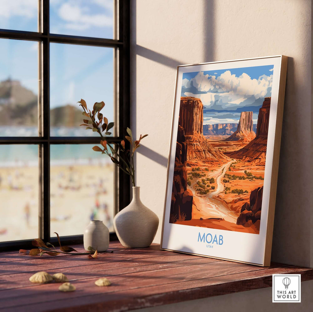 Moab travel poster displayed on a wooden table with a vase, showcasing stunning Utah landscapes and a scenic view.