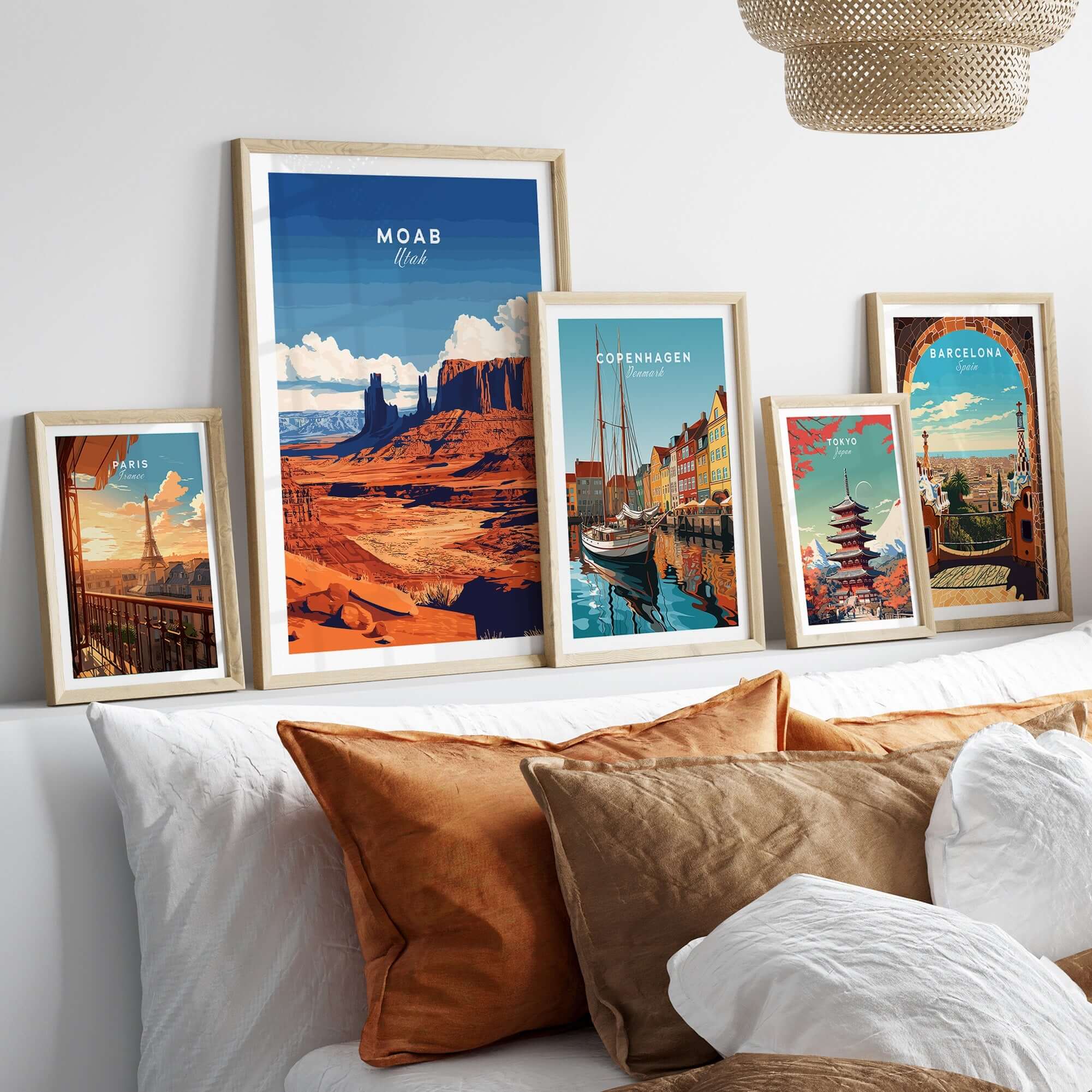 Moab Utah Wall Art collection featuring vibrant landscapes and cityscapes in stylish frames on a modern couch.