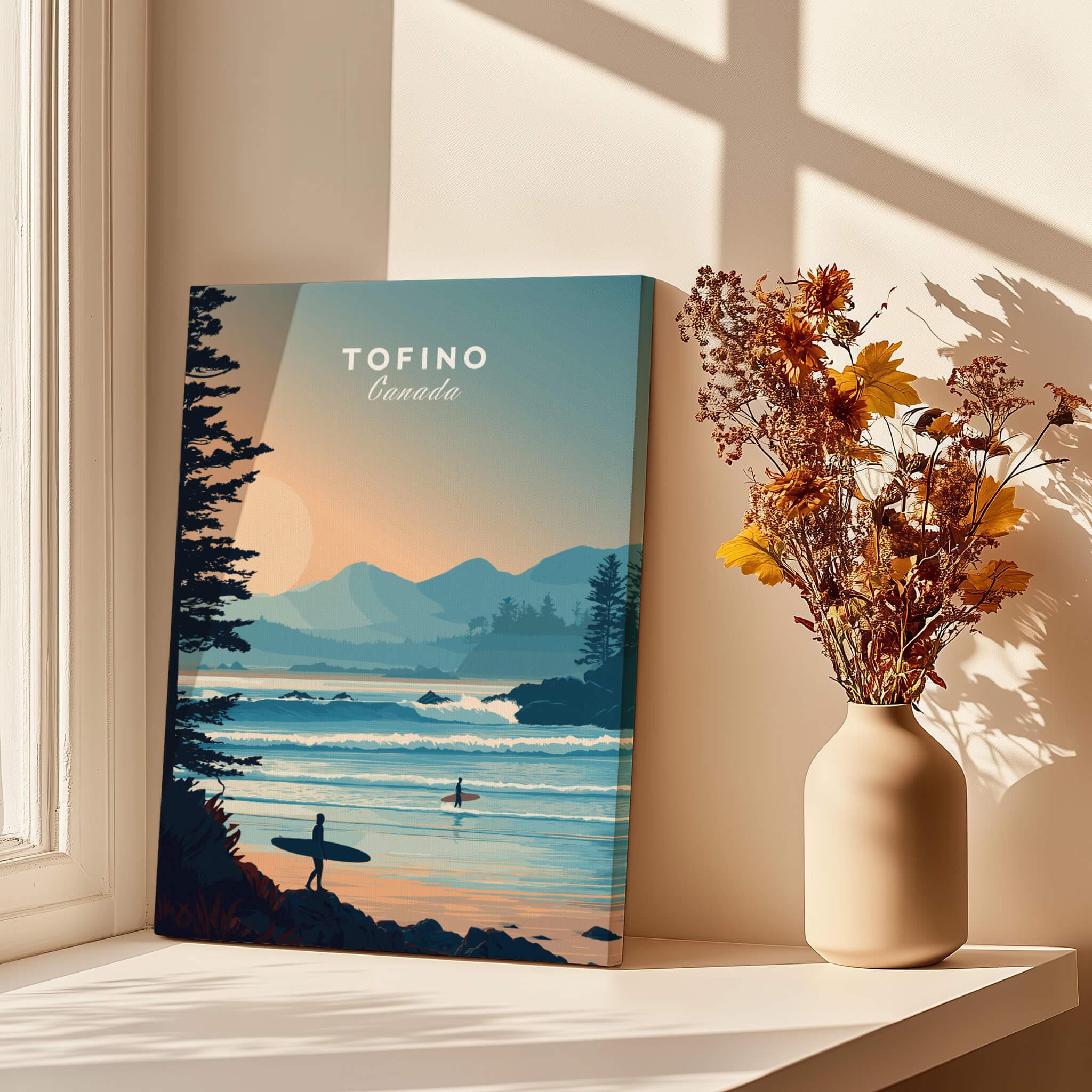 Tofino Canada travel poster wall art with surfers, ocean and mountains, styled on a window ledge beside a vase of dried flowers, sunlit home decor.