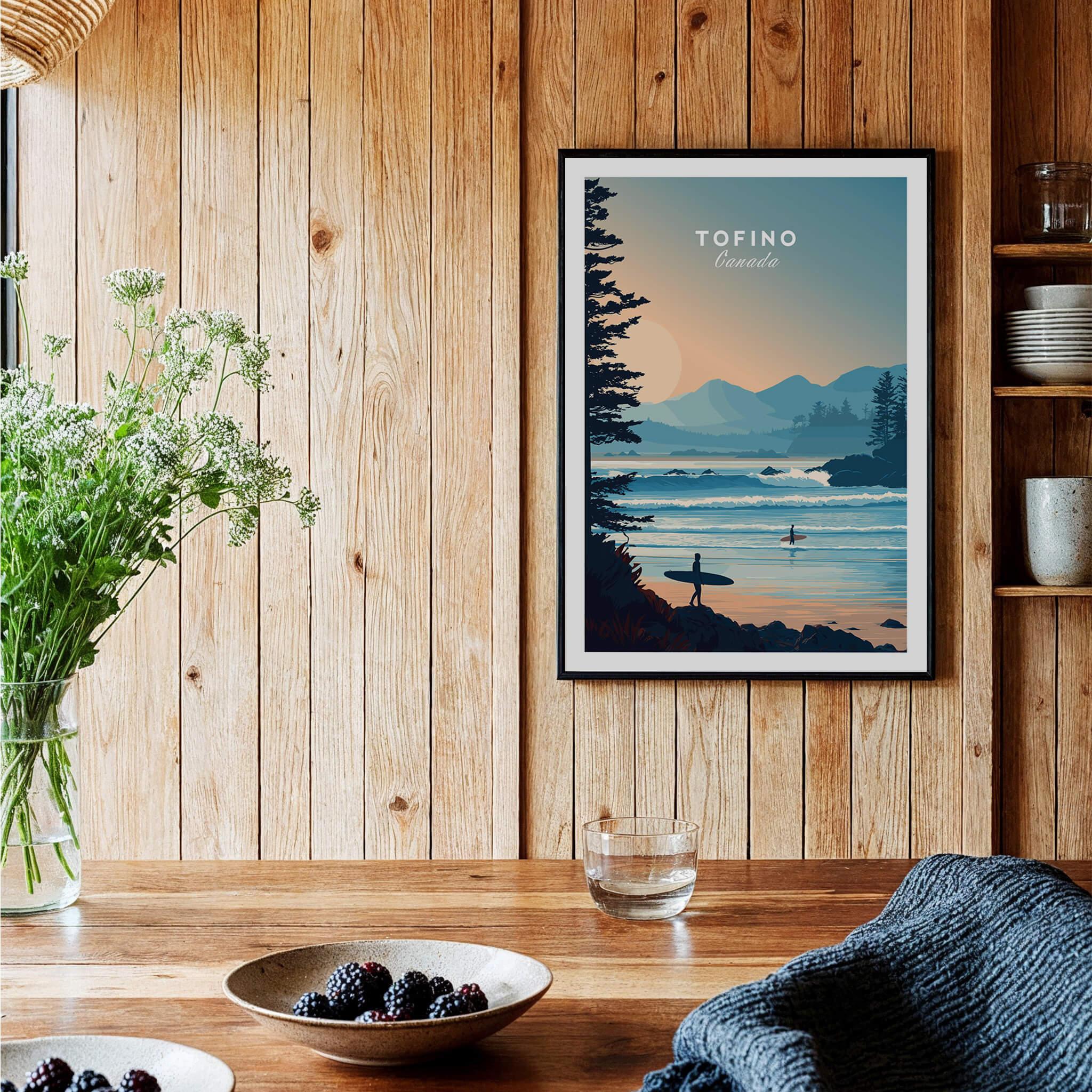 Tofino travel poster art print in a black frame on wood kitchen wall, cozy rustic decor
