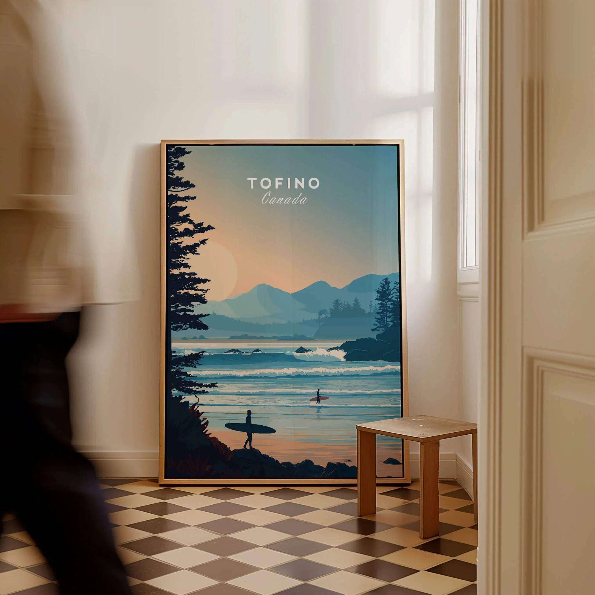 Framed Tofino Canada travel poster with surfers and coastal landscape leaned against wall