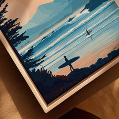 Framed canvas wall art closeup featuring surfers on a beach at sunset with waves and pine trees.