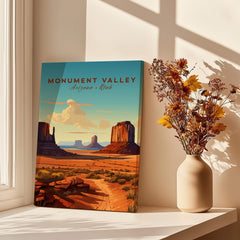 Monument Valley travel poster print on a windowsill beside a vase with dried flowers, sunlight and shadow accents.