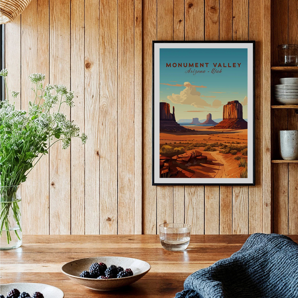 Framed Monument Valley travel poster art print on wood wall in cozy kitchen setting