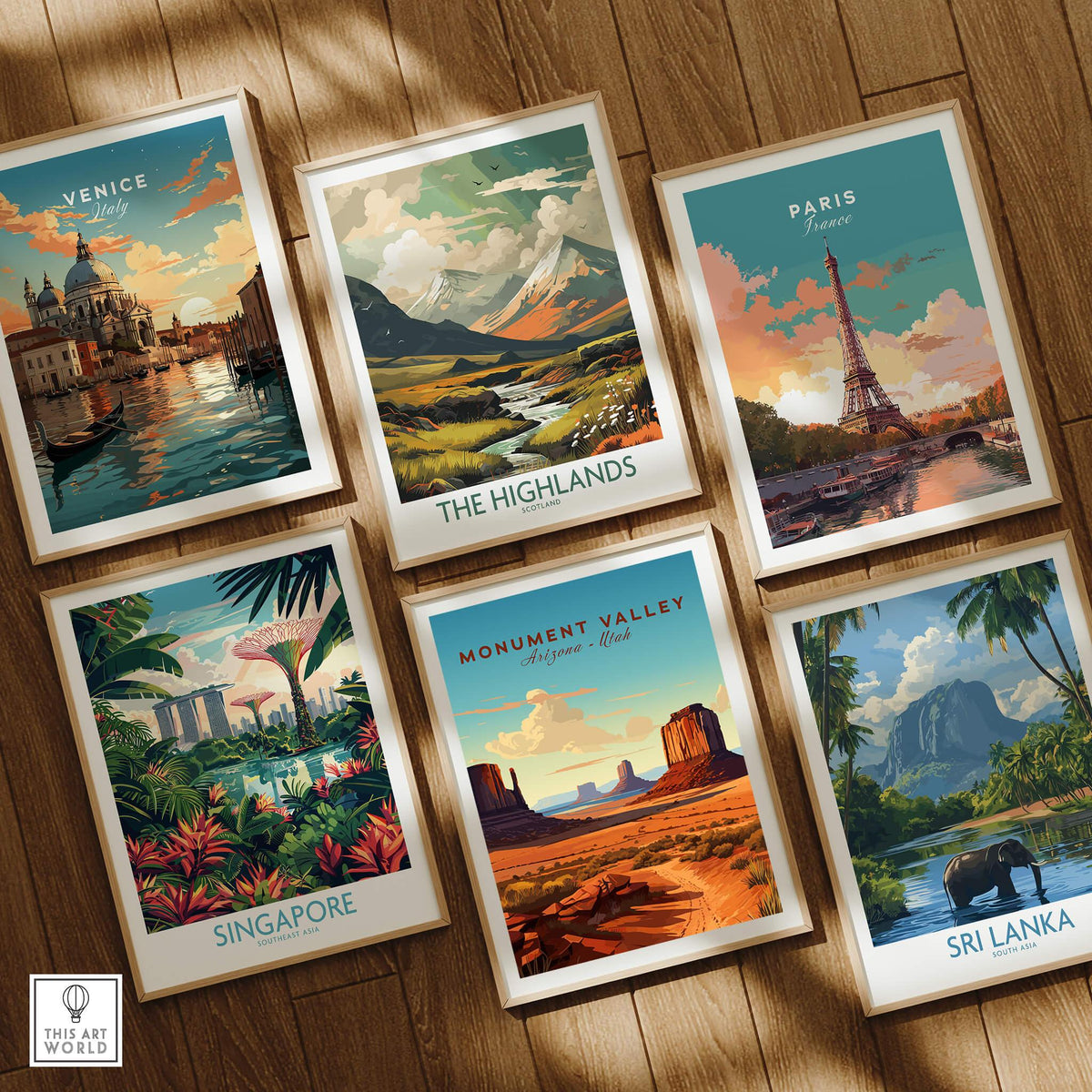 Set of six framed travel posters featuring Venice, Paris, Singapore, Monument Valley, the Highlands, and Sri Lanka on a wooden floor.