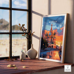 Moscow Travel Print - St. Basil's Cathedral Poster displayed on a table by a window with beach view.