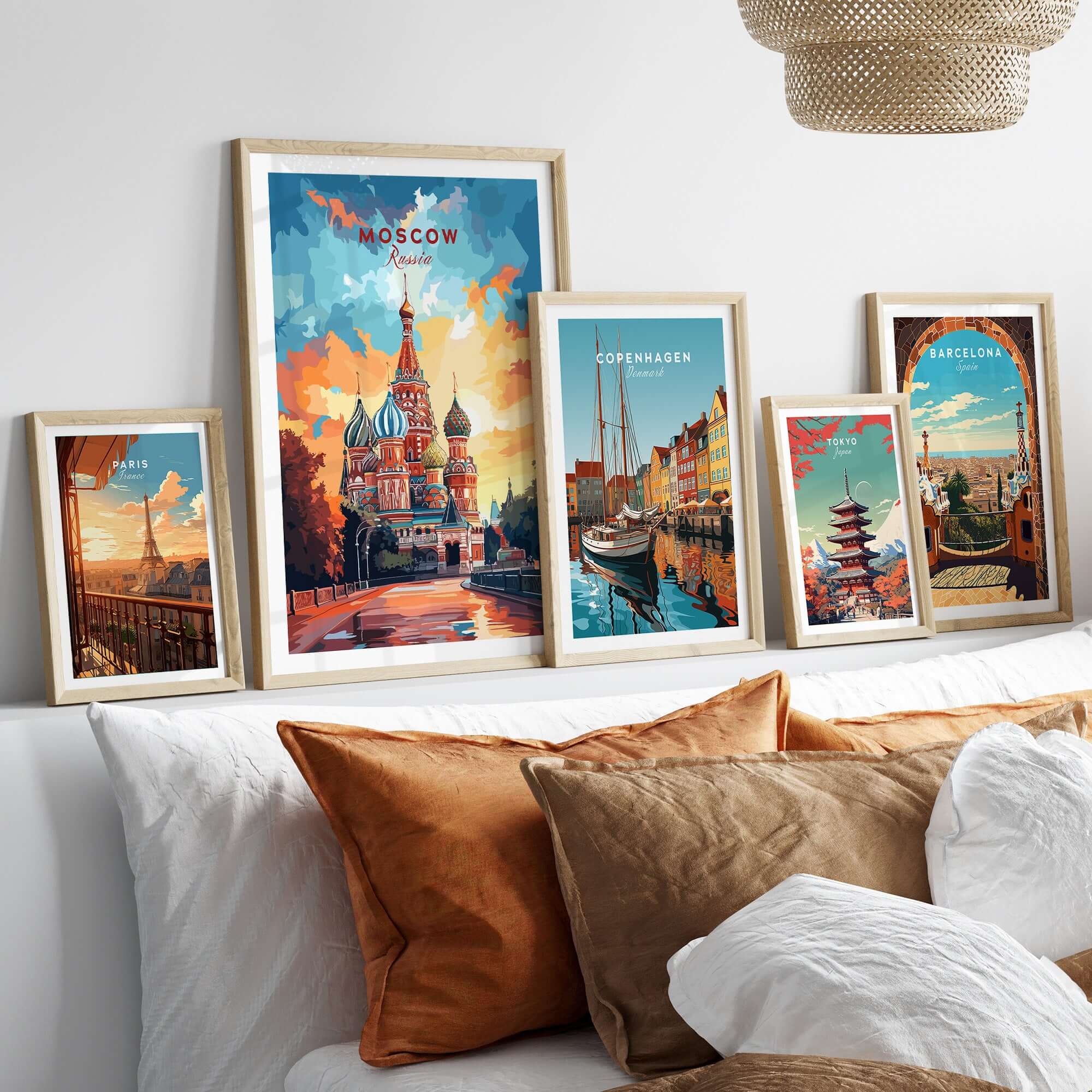 Moscow Wall Art - St. Basil's Travel Poster displayed in frames on a cozy sofa, showcasing travel-themed decor.