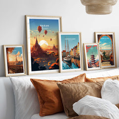 Vibrant Myanmar poster of Bagan sunset with hot air balloons displayed on a cozy bed with decorative pillows.