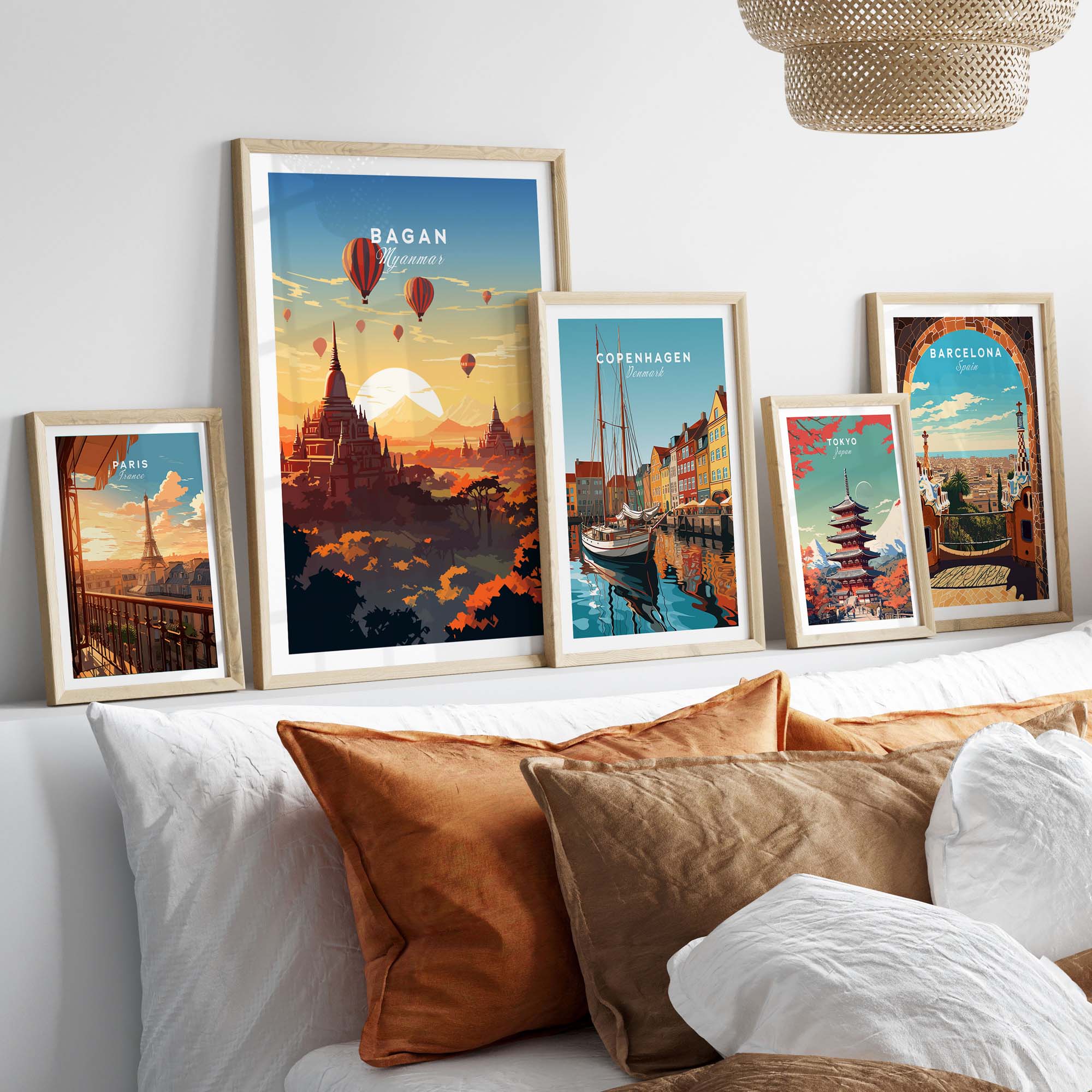 Vibrant Myanmar poster of Bagan sunset with hot air balloons displayed on a cozy bed with decorative pillows.