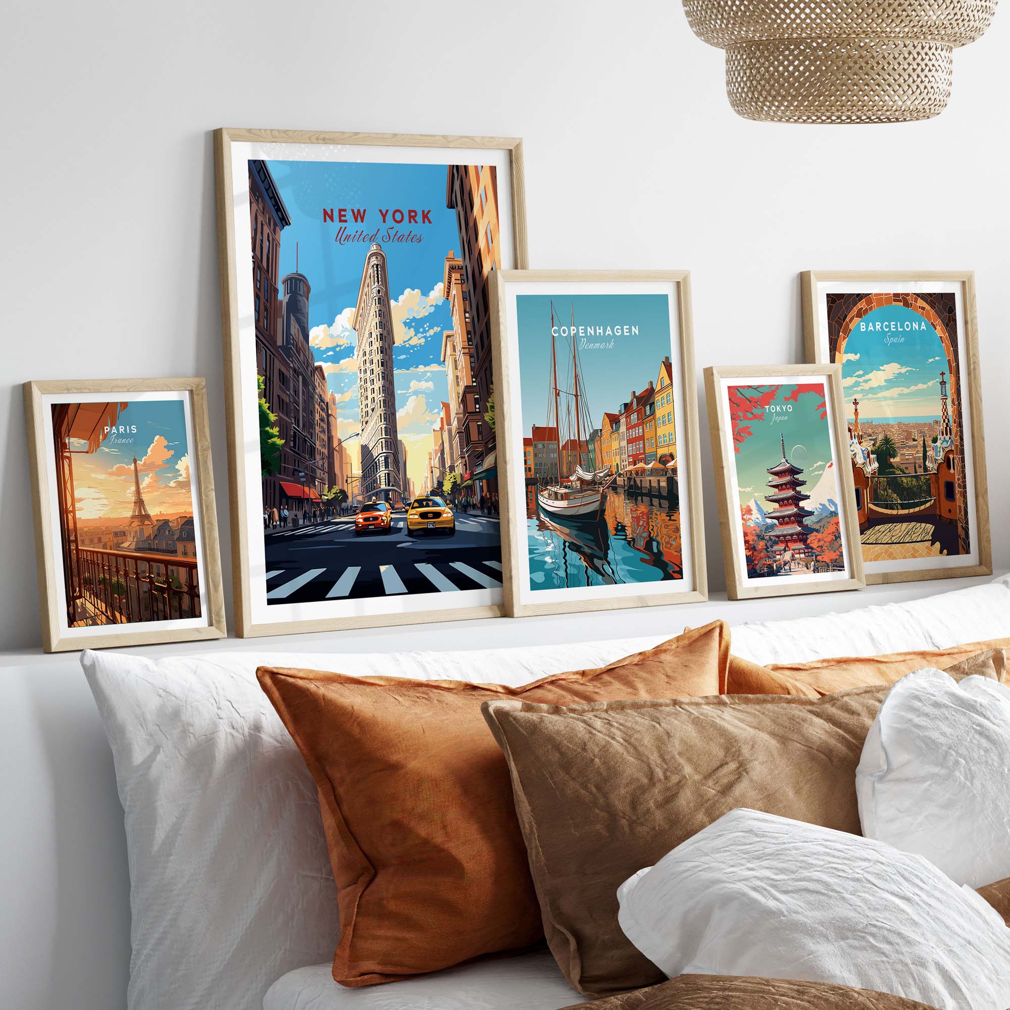 New York City print featuring the Flatiron Building, displayed with other city prints on a stylish bed.