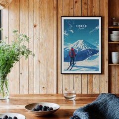 Niseko Travel Print - Japan displayed on a wooden wall above a table, showcasing stunning ski slopes and winter scenery.