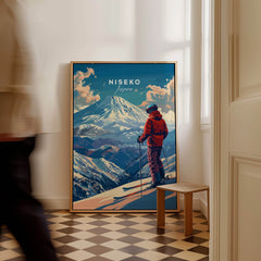 Niseko Wall Art - Japan featuring a skier against a backdrop of snowy mountains in a stylish interior setting.