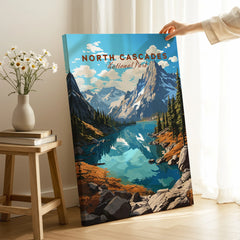 North Cascades National Park canvas print with a hand holding it, featuring a scenic mountain lake landscape in a home setting.